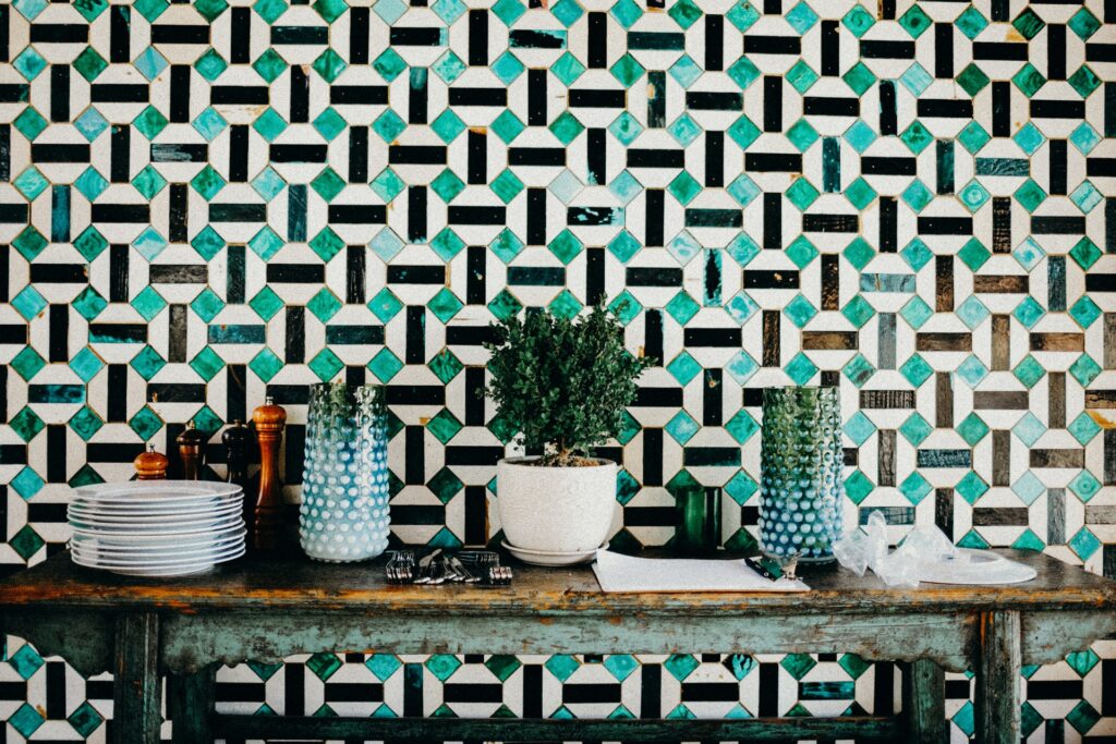 A wall with tile turquoise, white, and black tile stickers