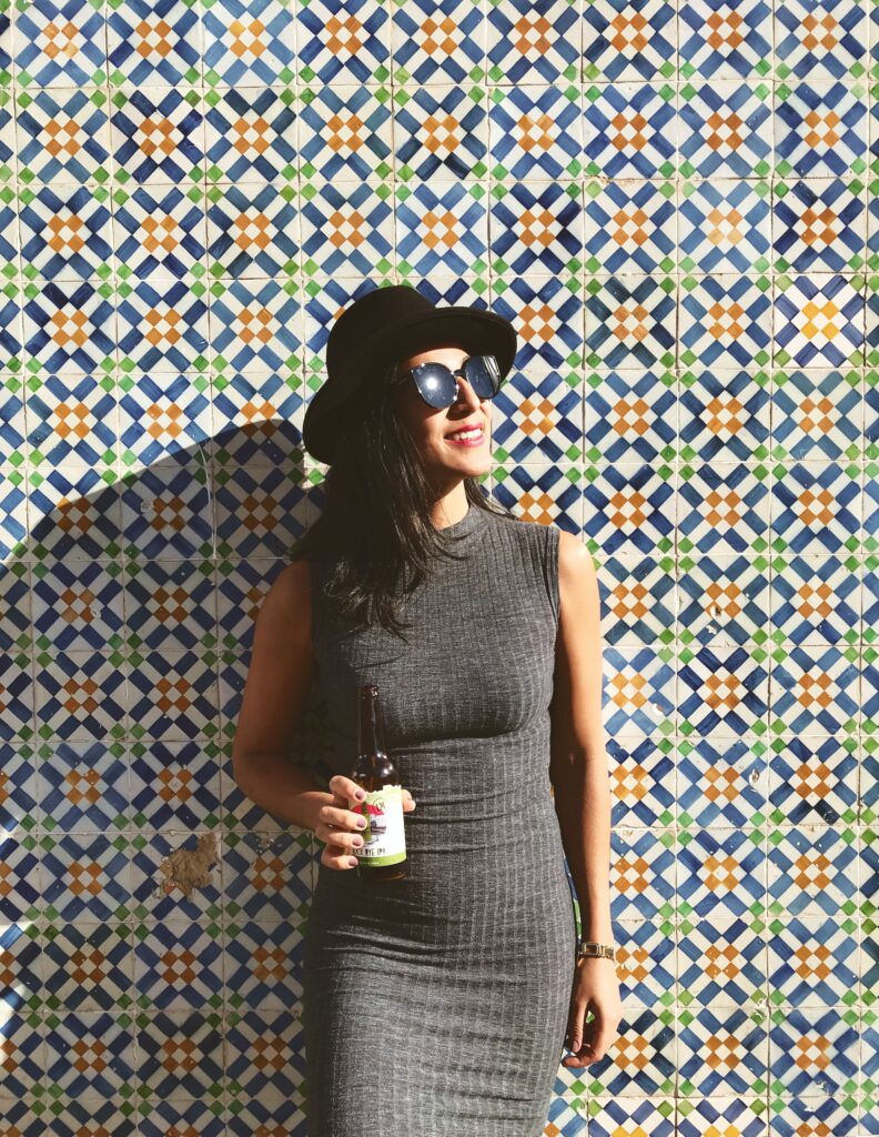 A woman standing in front of a tiled wall