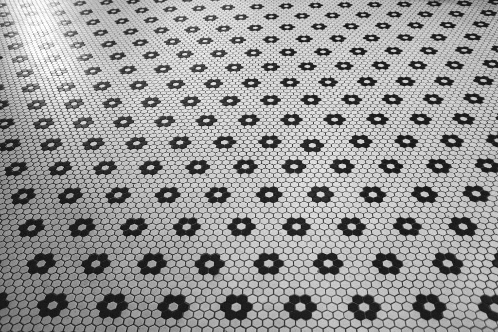 A floor with white and black printed tile stickers