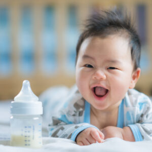 Hatchery_Asian Newborn baby smile with milk power bottle