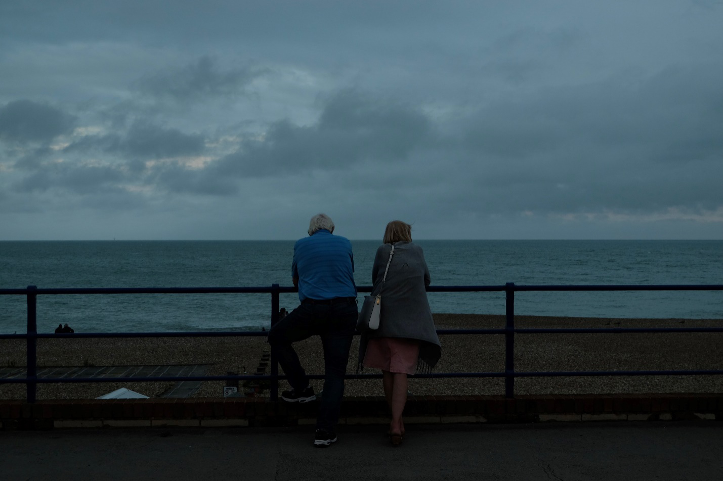 Two people overlooking the sea