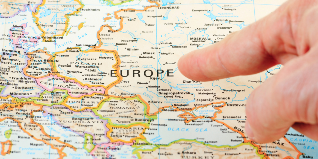 Image of a finger pointing at the European region on the map