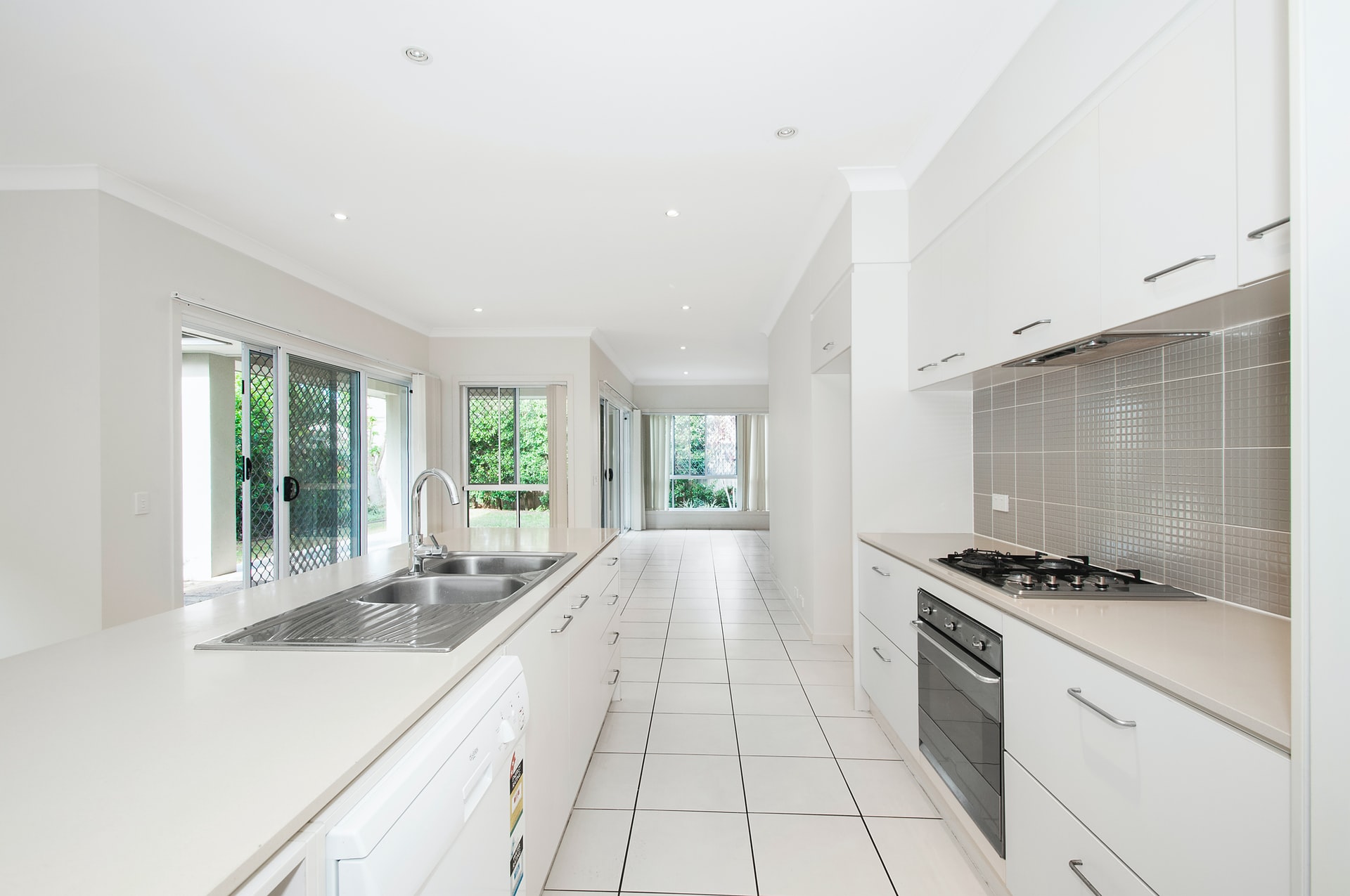 A kitchen with a white-tiled floor
