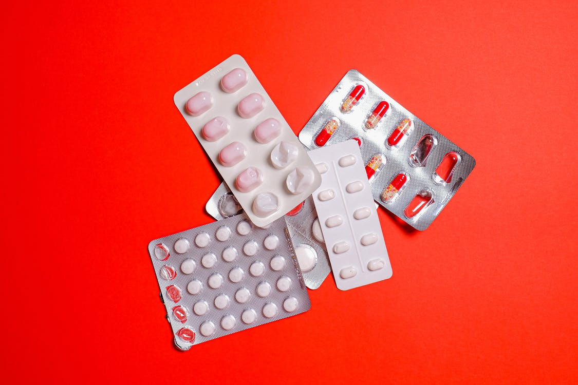 medicines on a red table