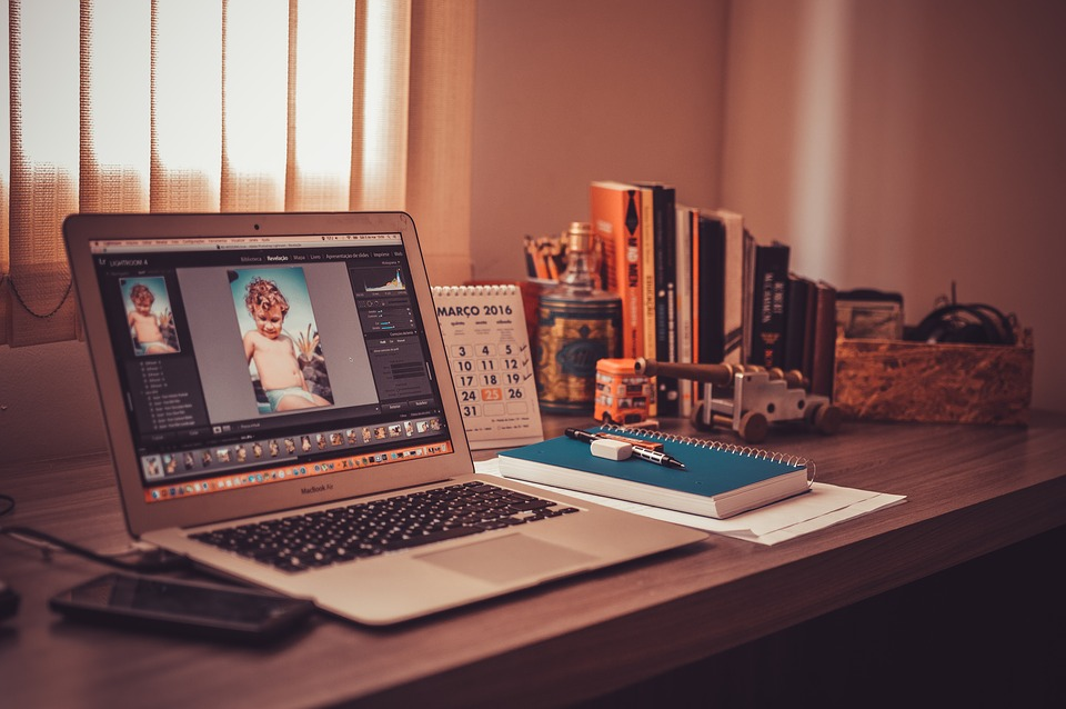 A laptop with a photo editing app to offer freelance services and make money online