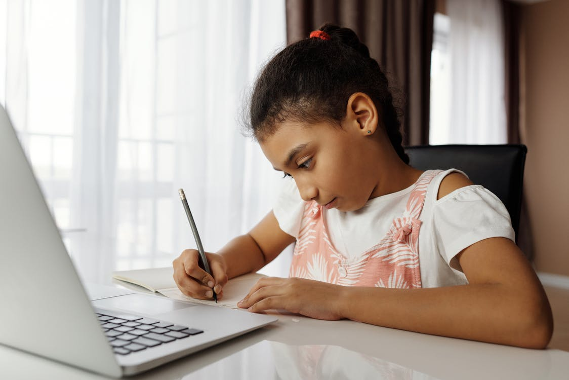 a student completing her homework after online school