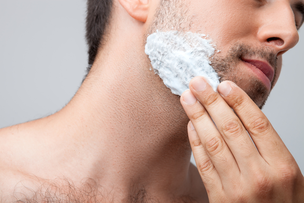 men applying beard foam