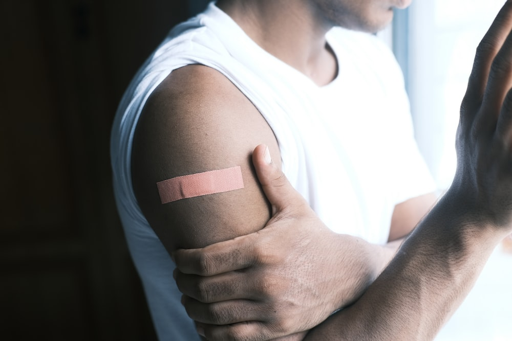 Person wearing a band aid on arm