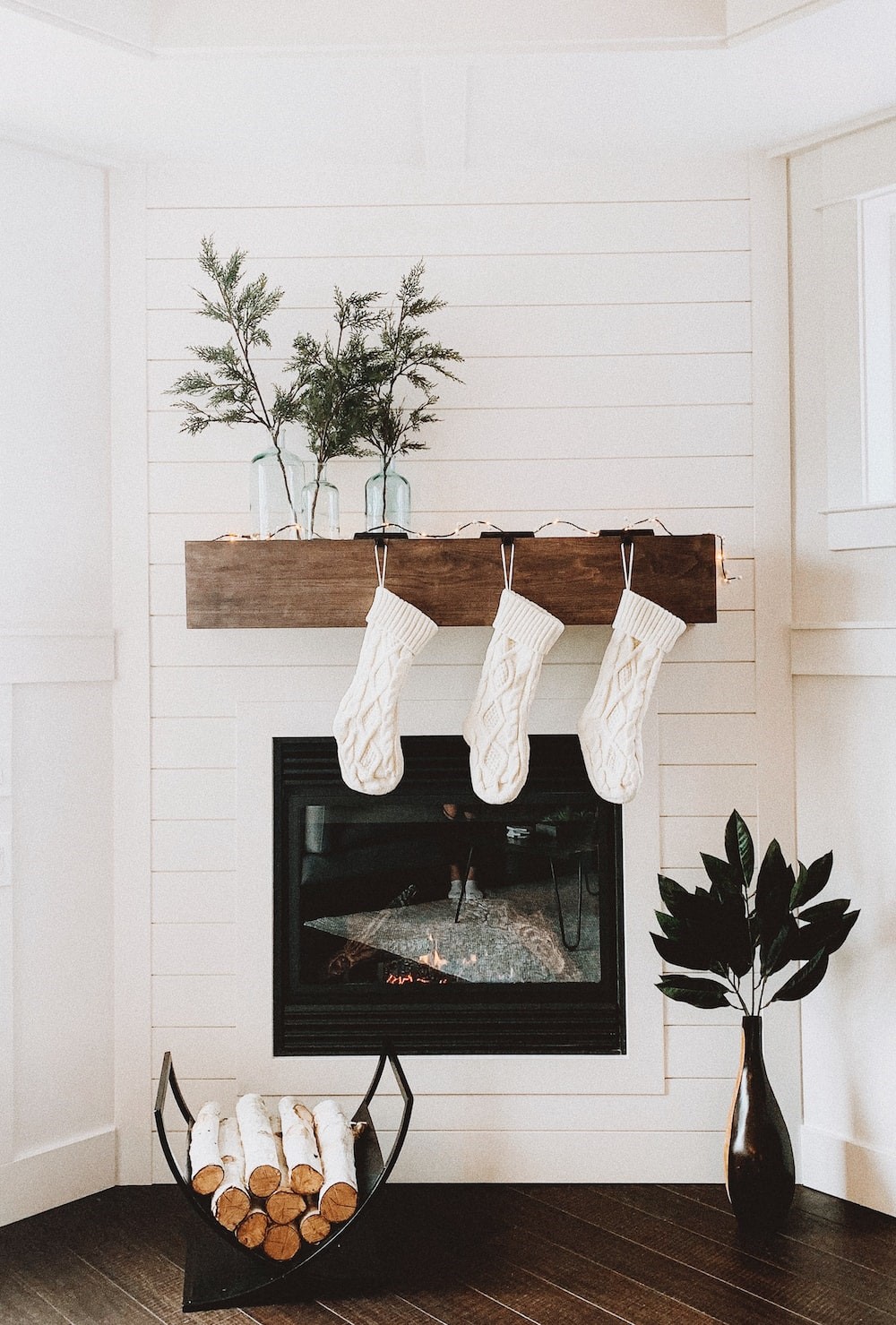 Fireplace decorated with lights and stockings