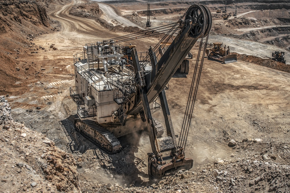 A crane excavating dirt at a mine