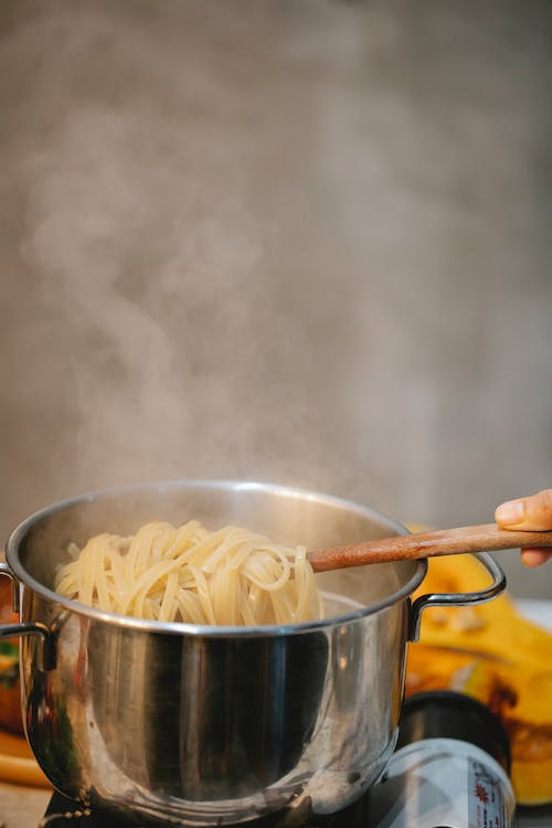 Boiling pasta strips in a pot