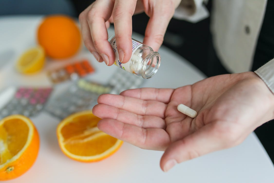 An image of a person taking pills