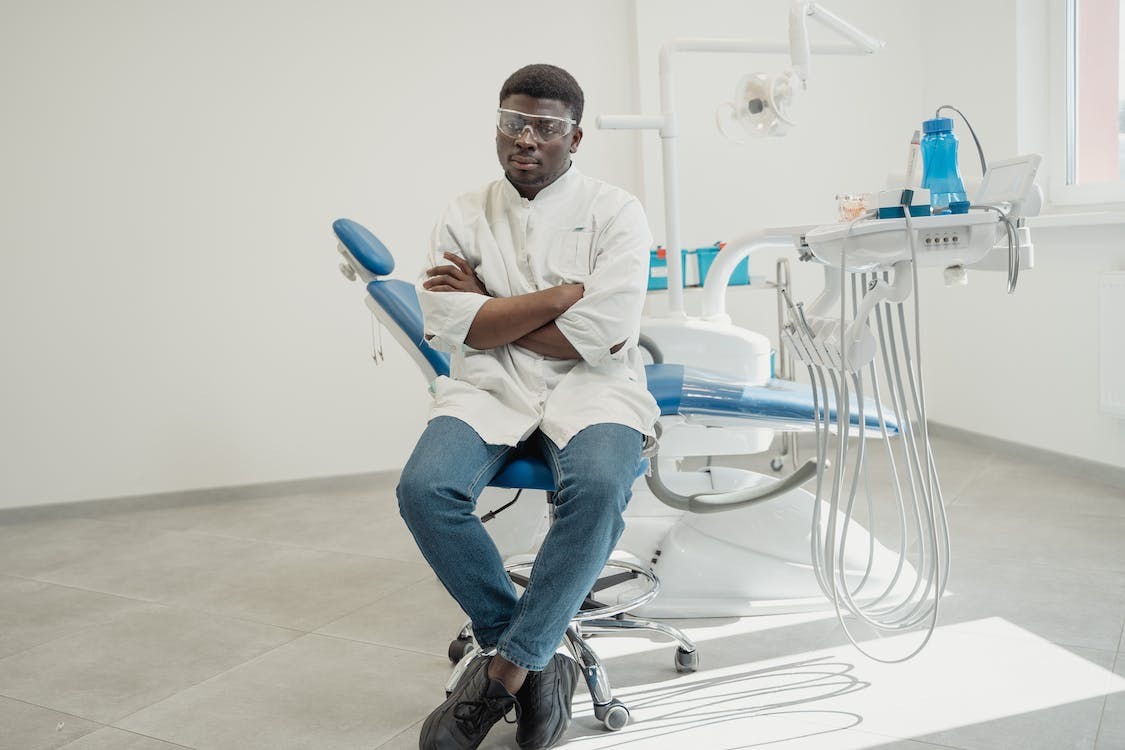 Dentist sitting on a Dental Chair