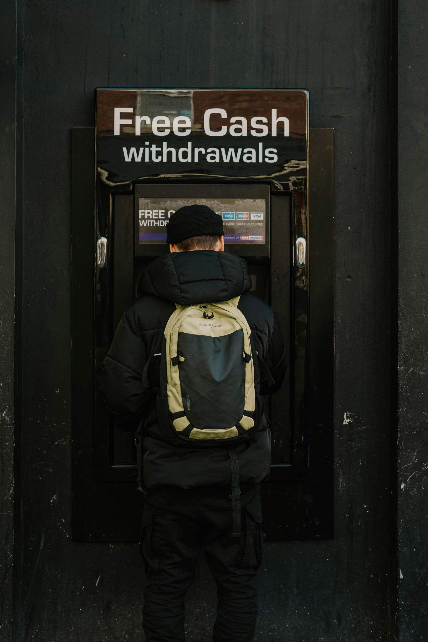 An image of a man using an ATM